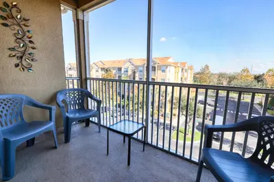 two chairs and a table on a balcony with a view at Windsor Hills Resort 3 Bedroom Condo 5 Minutes to Disney in Orlando