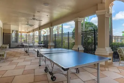a tennis court with two ping pong tables on a balcony at Windsor Hills Resort 3 Bedroom Condo 5 Minutes to Disney in Orlando