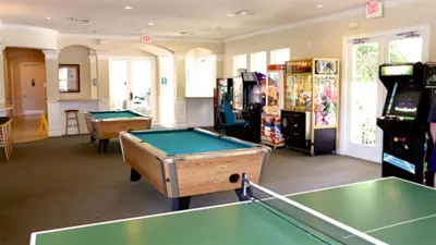 a room with two pool tables and arcade machines at Windsor Palms Resort 3 Bedroom Condo 6 Miles to Disney in Kissimmee