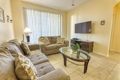 a living room with a couch and a glass table at Windsor Palms Resort 3 Bedroom Condo 6 Miles to Disney in Kissimmee