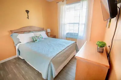 a bedroom with a bed and a television and a window at Windsor Palms Resort 3 Bedroom Condo 6 Miles to Disney in Kissimmee