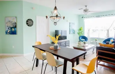 a living room with a dining room table and chairs at Windsor Palms Resort 3 Bedroom Condo 6 Miles to Disney in Kissimmee