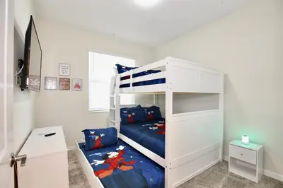 a bedroom with a white bunk bed with a blue mattress at Great apartment in Storey Lake resort with great amenities next to Disney! in Kissimmee