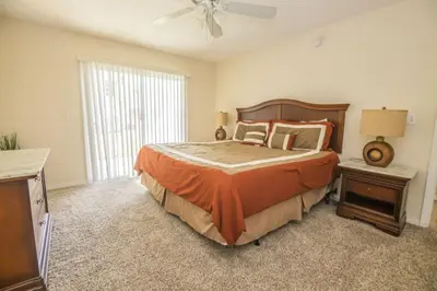 a bedroom with a large bed and a ceiling fan at Royal Palm Bay 3 Bedroom Condo Resort Pool 10 Min Disney in Kissimmee