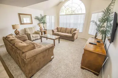 a living room with a couch and a table at Royal Palm Bay 3 Bedroom Condo Resort Pool 10 Min Disney in Kissimmee
