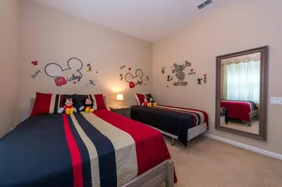 a bedroom with two beds and a mirror at Vista Cay Resort 3 Bedroom Condo 2 Miles to Universal Orlando in Orlando