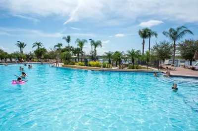 a pool at a resort with people in the water at Vista Cay Resort 3 Bedroom Condo 2 Miles to Universal Orlando in Orlando