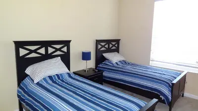 two beds sitting next to each other in a bedroom at 2Br 2Bath Condo Balcony 5min Conv Center 1496ft in Orlando