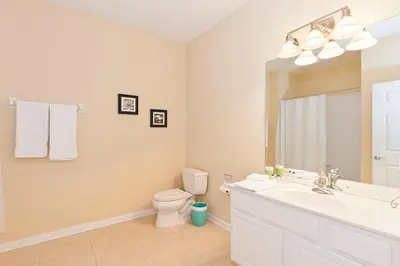 a bathroom with a sink and a toilet and a mirror at 2Br 2Bath Condo Balcony 5min Conv Center 1496ft in Orlando