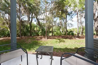 a picnic table and a bench on a porch at 3Br 3Bath Private Townhome 10min Disney 1270ft in Kissimmee