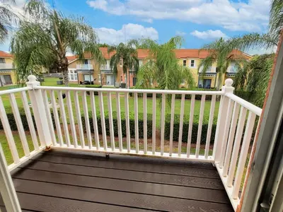 a balcony with a white railing and a building at Family Getaway Townhome at Lake Berkley 15min to Disney in Kissimmee