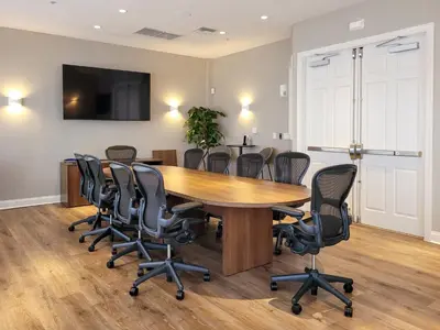 a conference room with a wooden table and chairs at 3Br 2Bath Condo Balcony 5min Conv Center 1410ft in Orlando