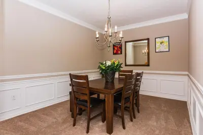 a dining room with a table and chairs and a mirror at Spacious Vista Cay Condo near Universal Studios in Orlando
