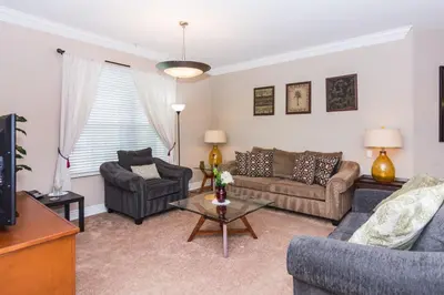 a living room with two couches and a tv at Spacious Vista Cay Condo near Universal Studios in Orlando