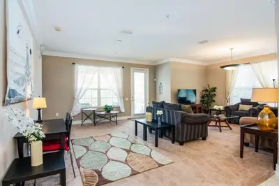 a living room with a couch and a table at Spacious Vista Cay Condo near Universal Studios in Orlando