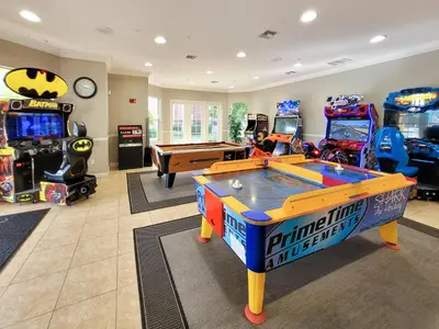 a living room with a pool table and arcade games at Spacious Vista Cay Condo near Universal Studios in Orlando