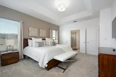 a white bedroom with a large bed and a window at 5Br 5Bath Pvt Home BBQ Pool 15min Disney 3056ft in Kissimmee