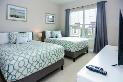 a hotel room with two beds and a window at 3 BR 3BA 1678ft 5min Disneyworld Resort style in Orlando