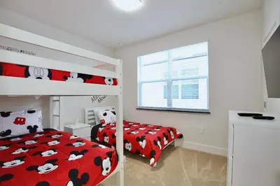 a bedroom with two bunk beds and a window at Great 4 bedroom townhouse in lux resort Hidden Forest, with private pool! in Orlando