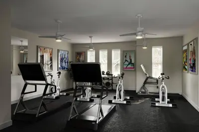 a gym with several exercise bikes in a room at Great 4 bedroom townhouse in lux resort Hidden Forest, with private pool! in Orlando