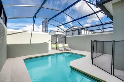 an indoor swimming pool with a glass roof at 4 Bed Storey Lake Resort With Lazy River townhouse in Kissimmee