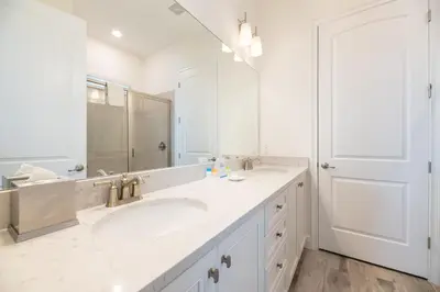a bathroom with two sinks and a large mirror at Lovely Cottage Near Disney With Margaritaville Resort & Island H20 Access - 8145Su in Orlando