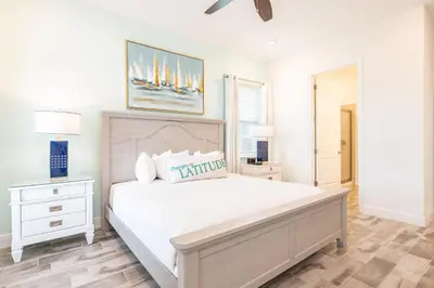 a white bedroom with a large bed and a window at Lovely Cottage Near Disney With Margaritaville Resort & Island H20 Access - 8145Su in Orlando
