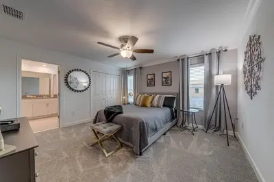 a bedroom with a bed and a ceiling fan at NEWLY LISTED Townhouse Storey Lake, Free Waterpark in Kissimmee