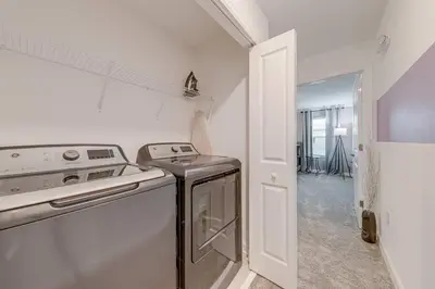 a white kitchen with a stove and a sink at NEWLY LISTED Townhouse Storey Lake, Free Waterpark in Kissimmee