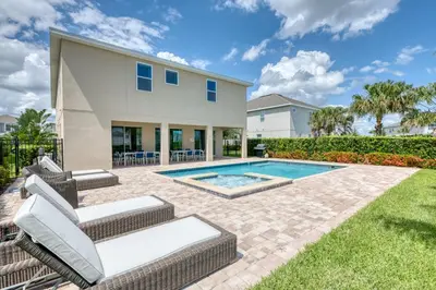 a home with a swimming pool and a house at Modern Home With Pool Table Near Disney With Waterpark & Resort Access At Encore Resort - 7644Ff in Kissimmee