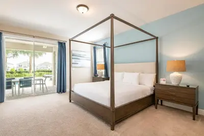 a bedroom with a four poster bed and a balcony at Modern Home With Pool Table Near Disney With Waterpark & Resort Access At Encore Resort - 7644Ff in Kissimmee