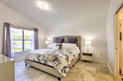 a bedroom with a bed and a window at 8 Mi to Disney World Home with Lanai and Game Room! in Kissimmee