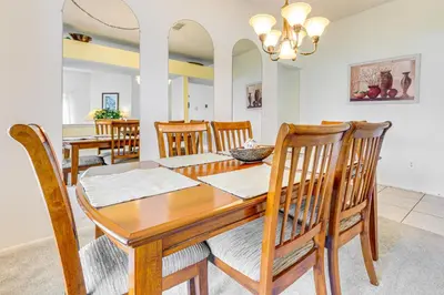 a dining room with a wooden table and chairs at 7 Mi to Disney Family-Friendly Home with Pool! in Kissimmee