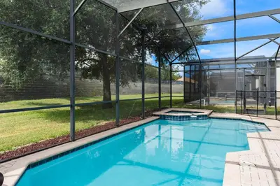 a swimming pool in front of a glass building at WindsorHills Villa Pool Resort Amenities Minutes to Disney in Orlando
