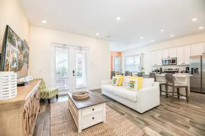 a living room with a white couch and a table at Fabulous Cottage With Private Pool Near Disney With Margaritaville Resort & Island H2O Access - 8094Kd in Orlando
