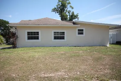 a white house with a yard at Beautiful large bedroom in Orlando