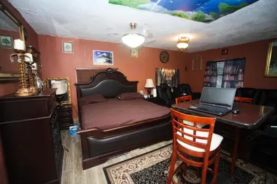 a bedroom with a bed and a desk with a laptop at Beautiful large bedroom in Orlando
