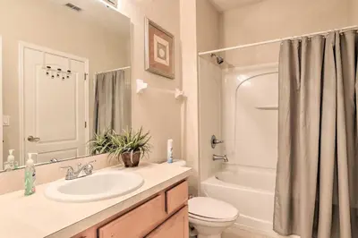 a bathroom with a sink and a toilet and a tub at 6 Mi to WDW Family-Friendly Townhome with Foosball! in Kissimmee