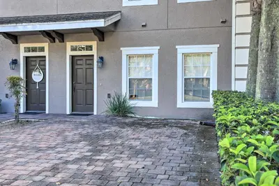 a house with a brick driveway in front of it at 6 Mi to WDW Family-Friendly Townhome with Foosball! in Kissimmee