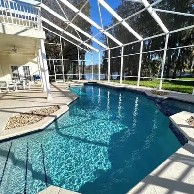 Mickeys Homestead - Stylish 4BR Lakefront Cottage with Huge South Facing Pool Hot Tub BBQ - 2 miles Disney!