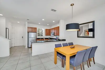a kitchen and dining room with a table and chairs at Regal Oaks Resort Townhouse in Kissimmee