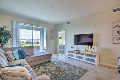 a living room with a couch and a flat screen tv at Kissimmee Condo about 10 Mi to Disney Attractions in Kissimmee