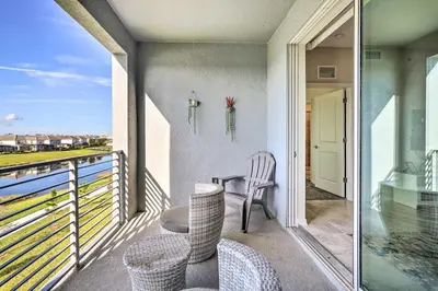 a balcony with chairs and a table and a view at Kissimmee Condo about 10 Mi to Disney Attractions in Kissimmee
