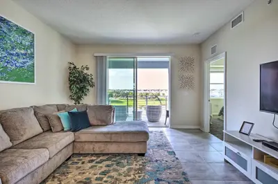 a living room with a couch and a flat screen tv at Kissimmee Condo about 10 Mi to Disney Attractions in Kissimmee