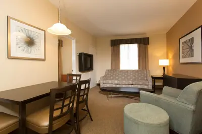 a living room with a couch and a table at staySky Suites I-Drive Orlando Near Universal in Orlando