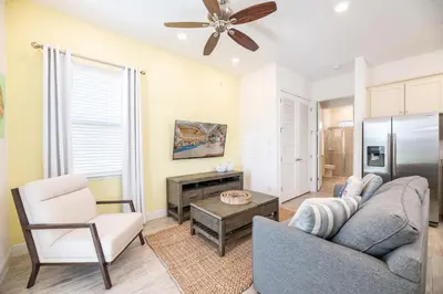a living room with a couch and a table at Delightful Cottage Near Disney With Margaritaville Resort & Island H20 Waterpark Access - 2956Sr in Orlando