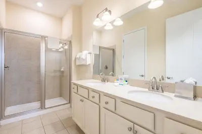 a bathroom with two sinks and a shower at Comfortable Cottage Near Disney With Margaritaville Resort & Island H20 Waterpark Access - 3017Sp in Orlando