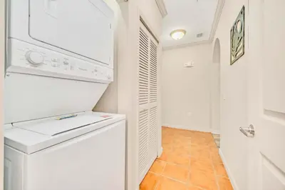 a laundry room with a washer and dryer at Spacious 2BR Condo with Pool , near Disney! in Orlando