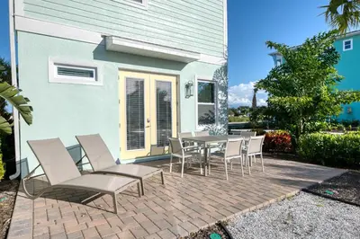 a table and chairs on a brick patio at Dreamy Cottage Near Disney With Margaritaville Resort & Island H20 Waterpark Access - 2950Sr in Orlando