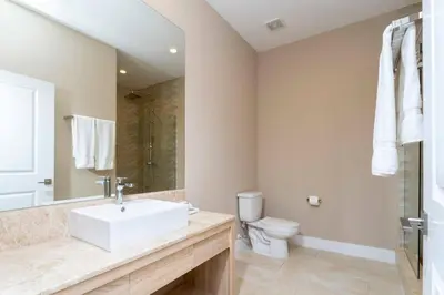 a bathroom with a white sink and a toilet at Beautiful Magic Village 4 Suites near Disney 7493 in Orlando